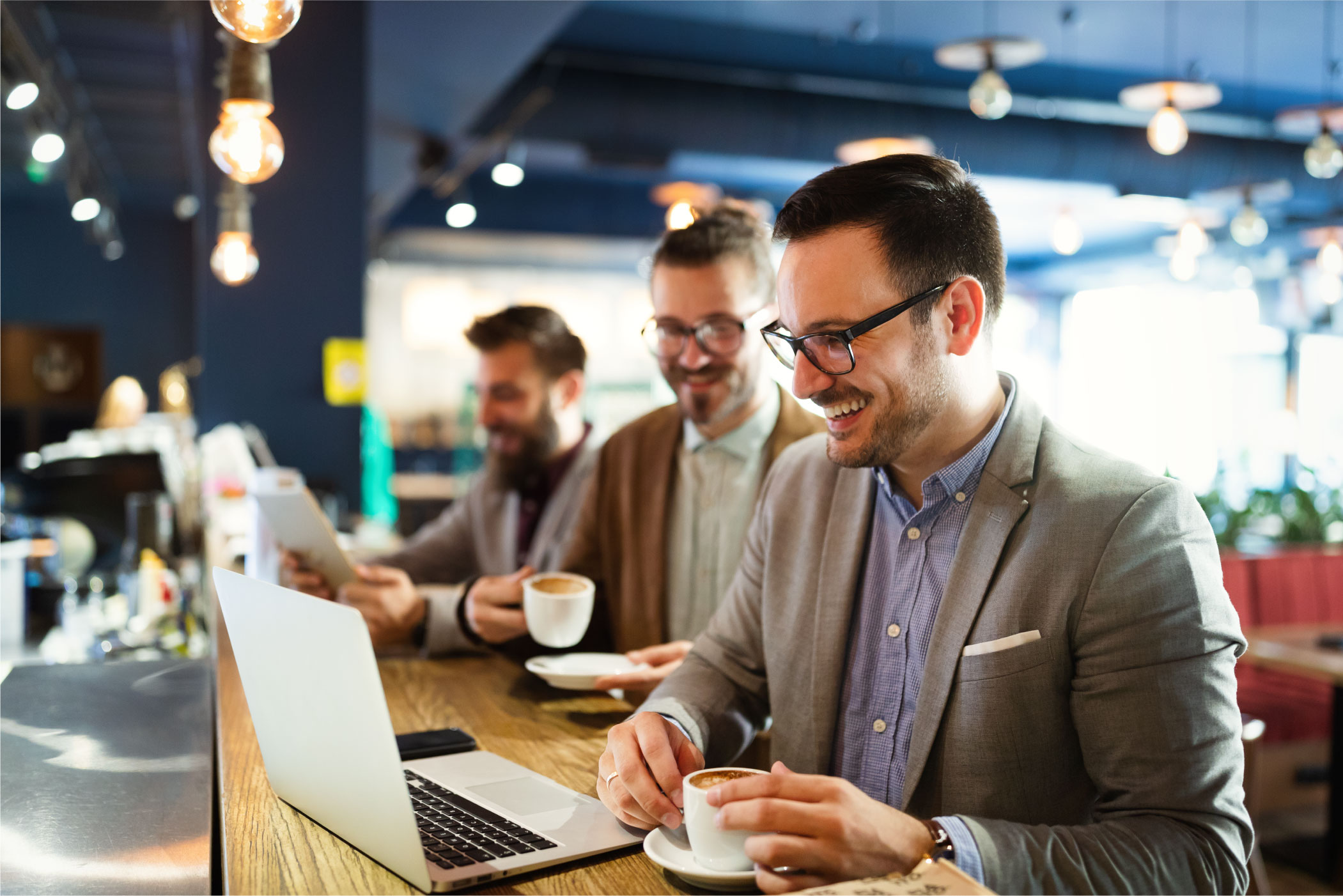 cheerful-businessmen-using-laptop-at-the-meeting-2021-08-28-17-42-58-utc-copy